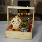 Ganesh Ji statue chocolate and nuts gift hamper with fairy lights in wooden tray by Tohfa Riwaz Mohali