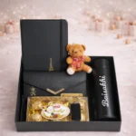 Luxury women’s gift set featuring ladies clutch notebook stainless steel bottle and chocolates