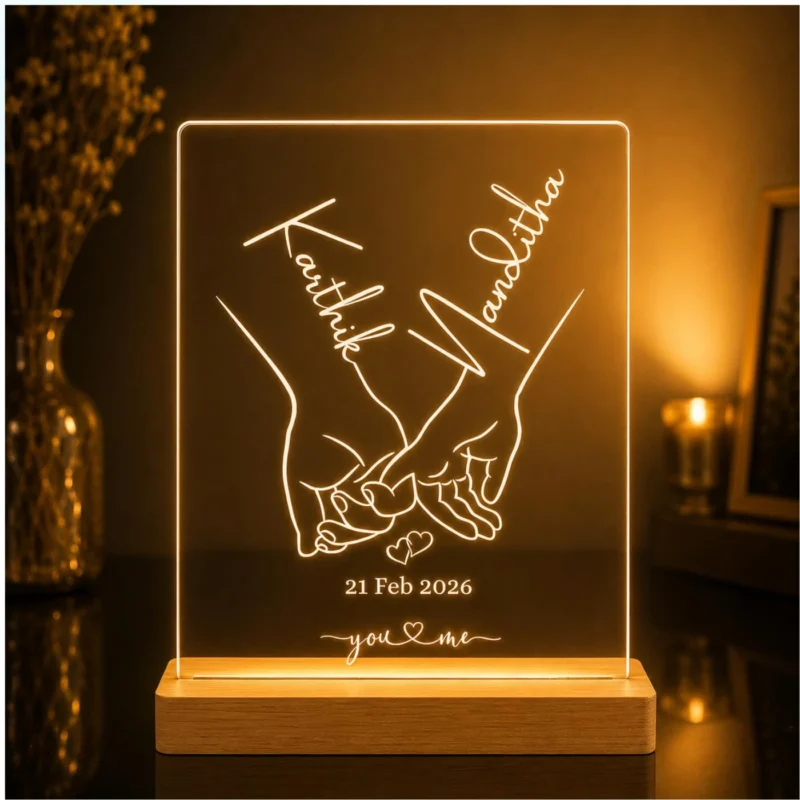 Personalized couple LED acrylic engraving lamp featuring interlocking hands, custom names and anniversary date with wooden base.