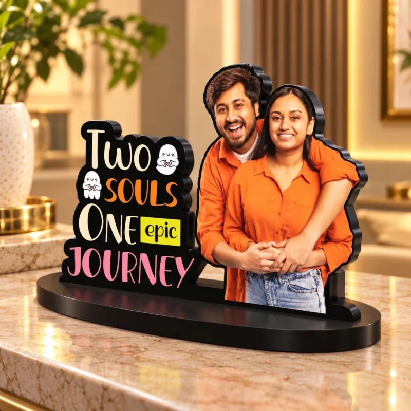 Personalized romantic couple MDF photo standee featuring a custom couple photo cutout with the message Two Souls One Epic Journey, displayed on a black base.