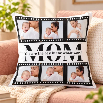 Personalized white Mom photo collage cushion featuring six custom mother and baby photos, black filmstrip design and the message You Are the Best in the Whole World.